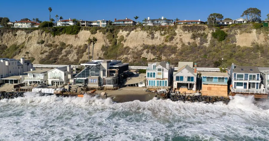 California beachfront building lost to surf as East Coast braces for nor'easter
