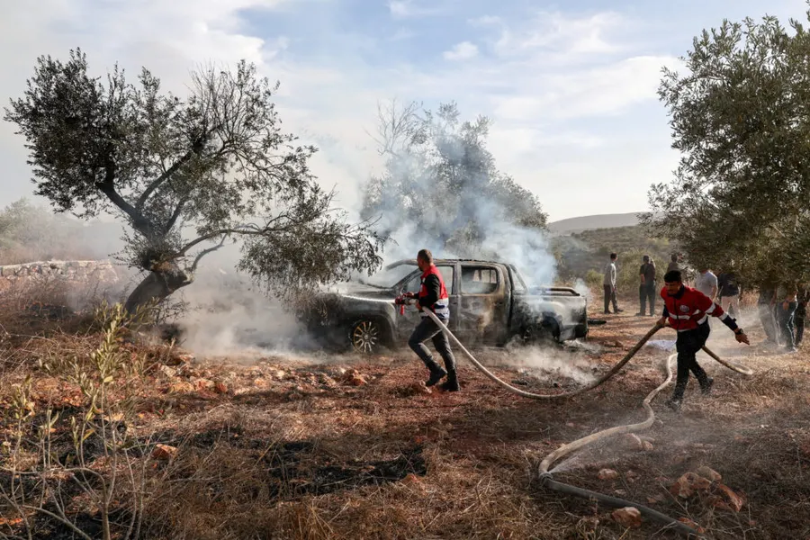 Israeli settlers attack West Bank olive harvesters, injuring US photojournalist